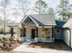 Inviting front porch with brick pillars, wood accents, and a stylish entrance door, offering a warm welcome at 54 Summer Dr, Walterboro, SC 29488