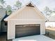 Well-maintained garage featuring a modern dark gray door, offering secure parking and storage at 54 Summer Dr, Walterboro, SC 29488