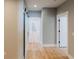 Bright hallway featuring light hardwood floors, neutral paint, and an open floor plan at 54 Summer Dr, Walterboro, SC 29488