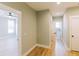 Hallway with natural light, hardwood floors, and access to the bedroom and bathroom at 54 Summer Dr, Walterboro, SC 29488
