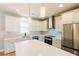 Bright kitchen features stainless appliances, white cabinets, quartz countertops, subway tile backsplash, and hardwood floors at 54 Summer Dr, Walterboro, SC 29488