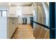 Bright kitchen features stainless appliances, white cabinets, quartz countertops, and hardwood floors at 54 Summer Dr, Walterboro, SC 29488
