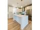 Spacious eat-in kitchen features a large island with white cabinets, stainless appliances, and hardwood floors at 54 Summer Dr, Walterboro, SC 29488