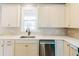 Bright kitchen features stainless appliances, white cabinets, quartz countertops, subway tile backsplash, and hardwood floors at 54 Summer Dr, Walterboro, SC 29488