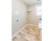 Well-lit laundry room with tile flooring, counter space, and shelving for storage at 54 Summer Dr, Walterboro, SC 29488