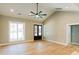 Spacious living room featuring high ceilings, a modern ceiling fan, and large windows, creating a bright atmosphere at 54 Summer Dr, Walterboro, SC 29488