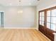 Spacious and bright living room with hardwood floors, modern lighting, and patio doors at 54 Summer Dr, Walterboro, SC 29488