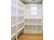 Pantry with white shelves and wood floors at 54 Summer Dr, Walterboro, SC 29488
