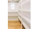 Spacious pantry with wood flooring, white shelves, and ample storage space at 54 Summer Dr, Walterboro, SC 29488