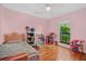 Bedroom with light pink walls, wood floors and window with backyard view at 58 Indigo Ln, Goose Creek, SC 29445