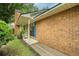 Inviting brick home exterior featuring a covered porch and charming blue shutters at 58 Indigo Ln, Goose Creek, SC 29445