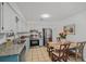 Eat-in kitchen featuring white cabinets, stainless steel appliances, granite countertops and light blue lower cabinets at 58 Indigo Ln, Goose Creek, SC 29445