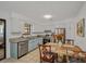 Eat-in kitchen featuring white cabinets, stainless steel appliances, granite countertops and light blue lower cabinets at 58 Indigo Ln, Goose Creek, SC 29445