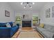 Cozy living room featuring a decorative fireplace, hardwood floors, and modern lighting at 58 Indigo Ln, Goose Creek, SC 29445
