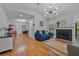 Bright living room with hardwood floors, a fireplace, and a modern chandelier at 58 Indigo Ln, Goose Creek, SC 29445