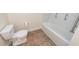 This is a bathroom with a toilet and a tub with a shower at 611 Grassy Hill Rd, Summerville, SC 29483