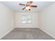 Spacious bedroom features neutral carpeting, two windows for natural light, and a ceiling fan at 611 Grassy Hill Rd, Summerville, SC 29483