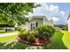 Charming home featuring manicured landscaping with lush greenery and a well-maintained lawn at 611 Grassy Hill Rd, Summerville, SC 29483