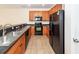 Functional kitchen boasts wood cabinets, black appliances, and ample counter space at 611 Grassy Hill Rd, Summerville, SC 29483