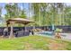 Backyard oasis featuring a pool, gazebo with seating, and beautifully landscaped greenery at 6190 Button Bush Dr, Ravenel, SC 29470