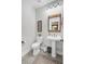 Classic half bath with pedestal sink, traditional fixtures and a decorative mirror at 6190 Button Bush Dr, Ravenel, SC 29470