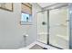 Bright bathroom with a glass shower, light gray paint, and wood look flooring at 6190 Button Bush Dr, Ravenel, SC 29470
