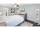 Bedroom with ceiling fan, TV, and wooden furnishings at 6190 Button Bush Dr, Ravenel, SC 29470