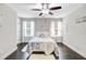 Bright bedroom with large windows, hardwood floors, and ceiling fan at 6190 Button Bush Dr, Ravenel, SC 29470