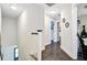 Bright hallway with hardwood floors and white trim leading to bedrooms at 6190 Button Bush Dr, Ravenel, SC 29470