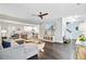 Open-concept living area featuring hardwood floors and seamless flow to the dining and kitchen spaces at 6190 Button Bush Dr, Ravenel, SC 29470