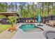 Outdoor pool and gazebo with lush greenery in a private backyard setting at 6190 Button Bush Dr, Ravenel, SC 29470