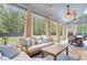 Inviting sunroom featuring a cozy seating area and an outdoor dining space at 6190 Button Bush Dr, Ravenel, SC 29470