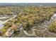 Aerial view of a home with a dock on the water surrounded by marshland and colorful foliage at 630 Cain Dr, Mount Pleasant, SC 29464