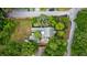 An aerial view of a charming home situated on a well-manicured lawn adorned with lush greenery and trees at 647 Ellis St, Mount Pleasant, SC 29464
