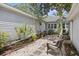 Private backyard space with stone accents, lush plants, and comfortable seating for outdoor living at 647 Ellis St, Mount Pleasant, SC 29464