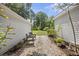 Landscaped backyard with a stone pathway and lush greenery, perfect for relaxation and outdoor enjoyment at 647 Ellis St, Mount Pleasant, SC 29464