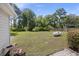 Large backyard with mature trees, lush grass, and a shed, providing ample space for outdoor activities at 647 Ellis St, Mount Pleasant, SC 29464