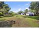 Spacious backyard with a shed, mature trees, and lush grass, perfect for outdoor activities and relaxation at 647 Ellis St, Mount Pleasant, SC 29464