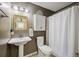 Compact bathroom featuring a pedestal sink, decorative mirror, and practical storage options at 647 Ellis St, Mount Pleasant, SC 29464