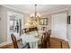 Traditional dining room with wooden furniture, decorative lighting, and easy access to kitchen at 647 Ellis St, Mount Pleasant, SC 29464