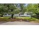 Traditional home featuring a well-maintained front lawn, mature trees, and a welcoming entrance, perfect for suburban living at 647 Ellis St, Mount Pleasant, SC 29464