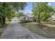 Beautiful home with a well-manicured lawn, mature trees, and a detached garage, creating a serene curb appeal at 647 Ellis St, Mount Pleasant, SC 29464