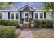 Inviting front entrance with brick steps, decorative plants, and a charming storm door at 647 Ellis St, Mount Pleasant, SC 29464