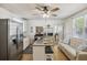 Open-concept kitchen with stainless appliances, seating, and natural light enhances the space at 647 Ellis St, Mount Pleasant, SC 29464
