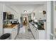 Open kitchen with stainless steel appliances, granite countertops and tile floors with access to dining area at 647 Ellis St, Mount Pleasant, SC 29464
