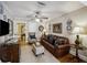 Well-lit living room with hardwood floors, leather sofa, and decorative plates on the wall at 647 Ellis St, Mount Pleasant, SC 29464