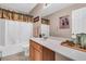 Bathroom features a shower with white curtain, vanity, and neutral walls at 67 Regency Oaks Dr, Summerville, SC 29485