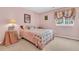 Pink bedroom features a floral quilt, vintage decor, and natural light from the window at 67 Regency Oaks Dr, Summerville, SC 29485