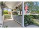 Relaxing covered front porch, adorned with hanging plants, a small fence and charming decor at 67 Regency Oaks Dr, Summerville, SC 29485