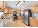 Bright eat-in kitchen with stainless steel appliances, light wood cabinetry, tile backsplash, and wood floors at 67 Regency Oaks Dr, Summerville, SC 29485